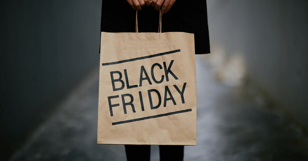 Black Friday customers - hands holding a bag with letters: Black Friday