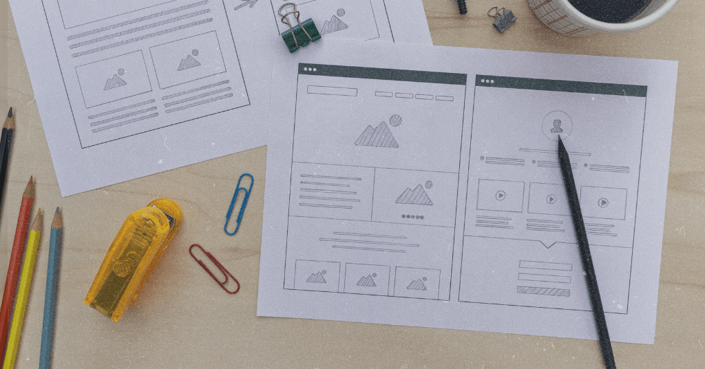 Paper with website wireframe symbolizing the process of creating a web.